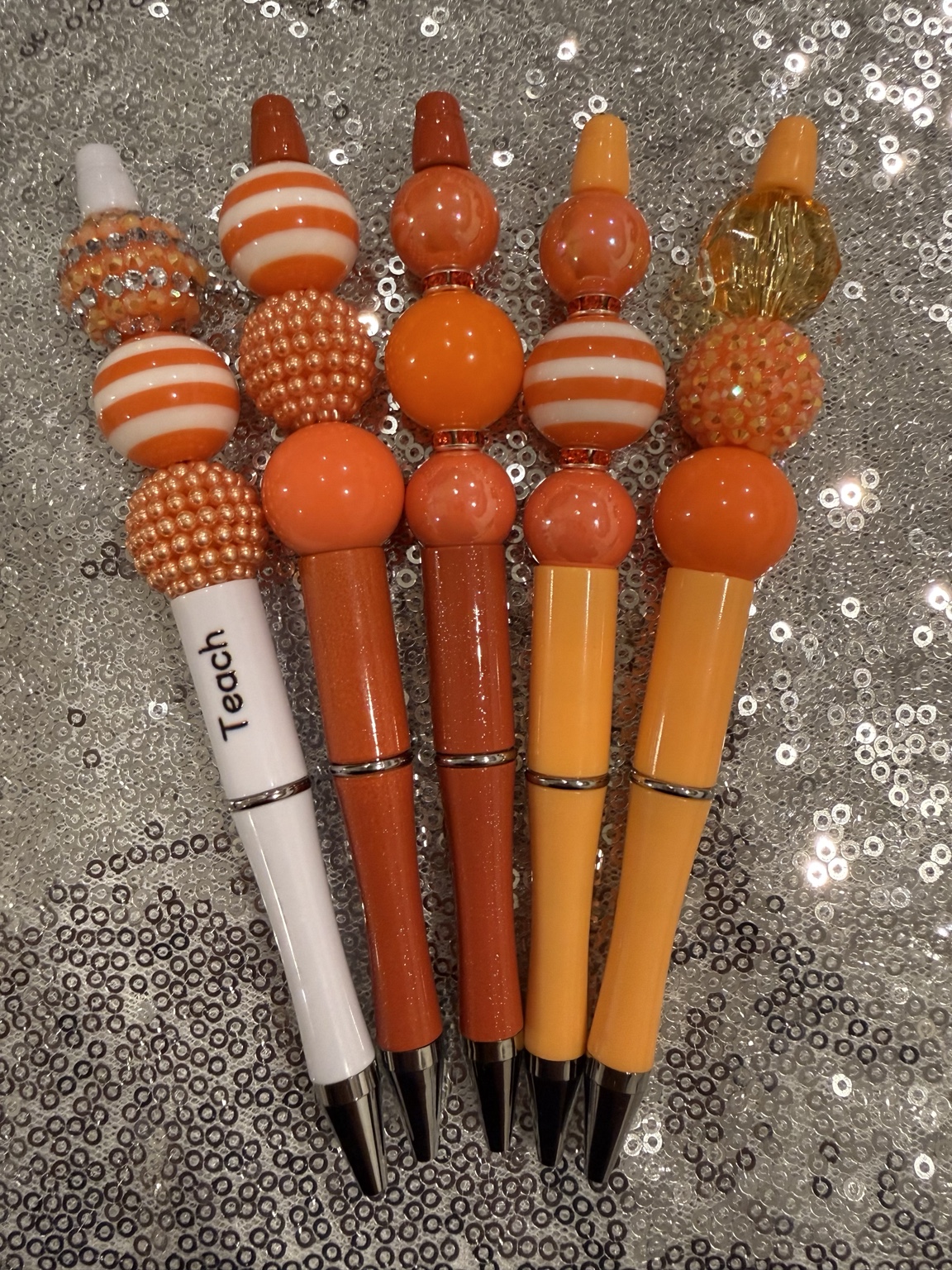Complete collection of orange handmade beaded pens